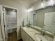 Bathroom features a double vanity with granite counters and a tiled shower at 437 Earnest Way, Kenly, NC 27542