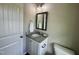 Well-lit half-bath with granite countertop, vanity, mirror, and fresh white paint at 437 Earnest Way, Kenly, NC 27542