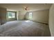 Large bedroom with a ceiling fan, large windows, and neutral colored carpet at 437 Earnest Way, Kenly, NC 27542