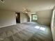 Spacious carpeted bonus room with sloped ceilings, ceiling fan, and natural light from the window at 437 Earnest Way, Kenly, NC 27542