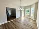 Bright dining room with hardwood floors, a modern chandelier, and large windows with a view at 437 Earnest Way, Kenly, NC 27542