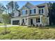 Charming two-story home with a two-car garage, a covered porch, and landscaped yard at 437 Earnest Way, Kenly, NC 27542