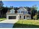 Charming two-story home with a two-car garage and landscaped yard with a treeline at 437 Earnest Way, Kenly, NC 27542
