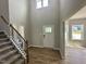 Grand two-story foyer with hardwood floors, staircase, and natural light showcases an inviting entrance at 437 Earnest Way, Kenly, NC 27542
