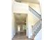 Grand foyer featuring a high ceiling, hardwood flooring, and an elegant staircase with iron spindles at 437 Earnest Way, Kenly, NC 27542