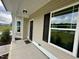 Welcoming front porch features large windows, neutral siding, black shutters and an outdoor light fixture at 437 Earnest Way, Kenly, NC 27542