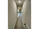 A carpeted hallway leading to a room with ceiling fan and natural light at 437 Earnest Way, Kenly, NC 27542