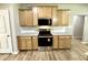 Well-equipped kitchen with granite countertops, stainless steel appliances, and wooden cabinets at 437 Earnest Way, Kenly, NC 27542