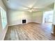 Cozy living room with fireplace, ceiling fan, and large windows offering ample sunlight at 437 Earnest Way, Kenly, NC 27542
