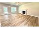 Bright living room boasts a fireplace, wood-look floors, and access to the outdoors at 437 Earnest Way, Kenly, NC 27542