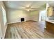 Spacious living room with fireplace, wood-look flooring, and abundant natural light at 437 Earnest Way, Kenly, NC 27542