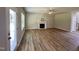 Bright living room featuring a decorative fireplace, ceiling fan, and durable wood-look floors at 437 Earnest Way, Kenly, NC 27542