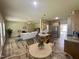 Open-concept living space with wood floors, fireplace, comfortable seating, and kitchen for easy living at 437 Earnest Way, Kenly, NC 27542