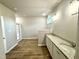 Beautiful bathroom featuring dual vanities, spacious shower, and wood look floors at 437 Earnest Way, Kenly, NC 27542