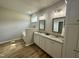 Dual vanities, soaking tub, and modern finishes in the main bathroom at 437 Earnest Way, Kenly, NC 27542