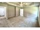 Spacious main bedroom with neutral carpet, ceiling fan, and doorway access to the bathroom at 437 Earnest Way, Kenly, NC 27542