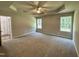 Expansive main bedroom features a tray ceiling, neutral carpet, and lots of natural light at 437 Earnest Way, Kenly, NC 27542