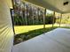Covered concrete patio with a view of a grassy backyard and tall trees at 437 Earnest Way, Kenly, NC 27542