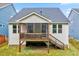 View of the rear exterior of the house showcasing the screened porch and backyard with stair access at 4408 Walker Hallow St, Raleigh, NC 27616