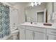 Well-lit bathroom featuring a shower-tub combo, decorative shower curtain and a single sink with a large mirror at 4408 Walker Hallow St, Raleigh, NC 27616