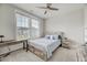 Bedroom with carpet, a ceiling fan, two windows, and a bed between two nightstands at 4408 Walker Hallow St, Raleigh, NC 27616