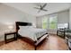 Cozy bedroom with natural light, hardwood floors, a ceiling fan, and a comfortable queen bed at 4408 Walker Hallow St, Raleigh, NC 27616