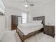 Comfortable bedroom features a queen bed, large dresser, nightstand, carpeted floors and lots of natural light at 4408 Walker Hallow St, Raleigh, NC 27616