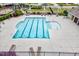 Inviting community swimming pool with clear water, marked lanes, lounge chairs, and nearby playground at 4408 Walker Hallow St, Raleigh, NC 27616