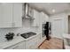 Modern kitchen featuring white cabinets, stainless steel appliances, and a gas stovetop at 4408 Walker Hallow St, Raleigh, NC 27616