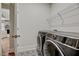 Laundry room with patterned floor tiles, a wire rack, and front loading washer and dryer at 4408 Walker Hallow St, Raleigh, NC 27616