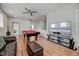 Large living room with a pool table, TV, leather couch, and hardwood floors at 4408 Walker Hallow St, Raleigh, NC 27616