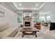 Cozy living room with a stone fireplace, recessed lighting, and lots of natural light at 4408 Walker Hallow St, Raleigh, NC 27616