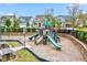 Community playground with slides, climbing structures, and picnic area, surrounded by green space and homes at 4408 Walker Hallow St, Raleigh, NC 27616