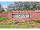 The BELMONT signage surrounded by green plants and vibrant flowers sits on a brick wall at 4408 Walker Hallow St, Raleigh, NC 27616