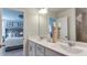 An elegant bathroom features a double vanity with framed mirror and view into the main bedroom at 444 Deercroft Dr, Apex, NC 27539