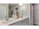 Bathroom featuring a double vanity with framed mirror and view into a walk-in closet at 444 Deercroft Dr, Apex, NC 27539