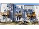 Rear view of townhomes with private wooden balconies and well-maintained lawn at 444 Deercroft Dr, Apex, NC 27539