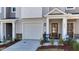 Magnolia Trace townhome with attached garage, a covered front entry, and manicured landscaping at 444 Deercroft Dr, Apex, NC 27539