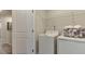 Bright laundry room with side-by-side washer and dryer and wire shelving for storage at 444 Deercroft Dr, Apex, NC 27539