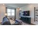Comfortable living room with large window, modern decor, and stylish furnishings at 444 Deercroft Dr, Apex, NC 27539