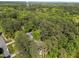 Aerial shot of property nestled in a neighborhood, surrounded by trees at 4533 Wood Valley Dr, Raleigh, NC 27613