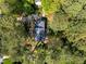 Aerial view of a home surrounded by lush greenery and mature trees at 4533 Wood Valley Dr, Raleigh, NC 27613