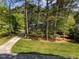 Spacious lot with mature trees surrounding a beautiful home and long private driveway at 4533 Wood Valley Dr, Raleigh, NC 27613