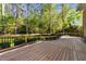 Inviting outdoor deck space with black metal railing overlooking the lush green lawn at 4533 Wood Valley Dr, Raleigh, NC 27613