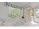 Bathroom features a large soaking tub, decorative window, and glass enclosed shower at 4533 Wood Valley Dr, Raleigh, NC 27613