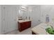 Bathroom with dual vanities, tile floors, and white painted walls at 4533 Wood Valley Dr, Raleigh, NC 27613