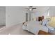 Spacious bedroom with neutral carpet, ceiling fan, and view of bathroom at 4533 Wood Valley Dr, Raleigh, NC 27613