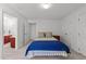 Bright bedroom featuring white walls, carpeted floor, and ensuite bathroom entrance at 4533 Wood Valley Dr, Raleigh, NC 27613