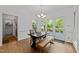 Bright dining room with hardwood floors, a chandelier, and access to the deck at 4533 Wood Valley Dr, Raleigh, NC 27613