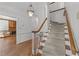Foyer with hardwood floors, staircase, and views into the adjacent living spaces at 4533 Wood Valley Dr, Raleigh, NC 27613
